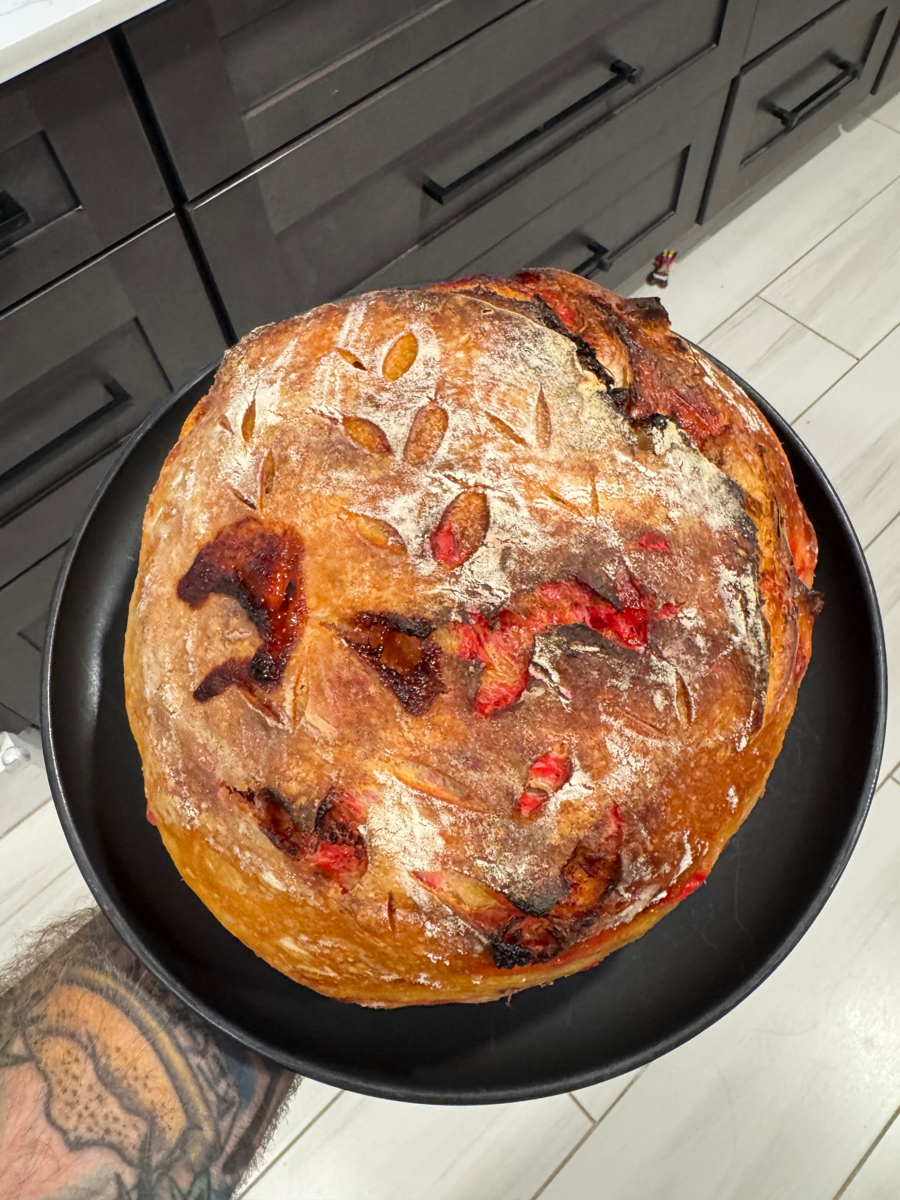 Strawberry sourdough loaf in a black pan